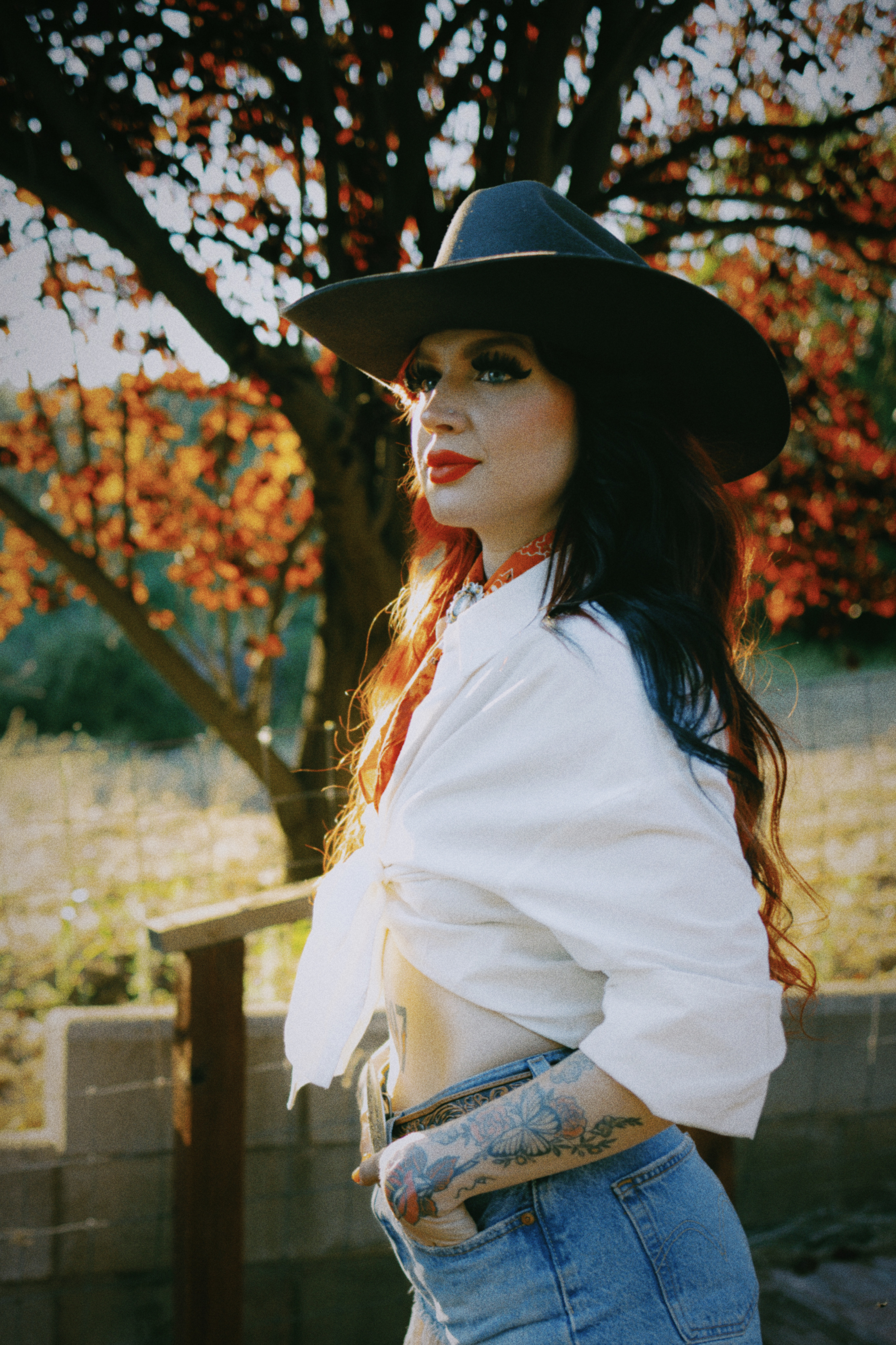 Golden-hour portrait in a black cowboy hat